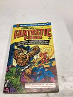 Front cover of Fantastic Four comic book showing title and artwork of superheroes battling villains
