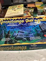 Full layout of Goosebumps Terror in the Graveyard game board, showing haunted graveyard design with game title and taglines in English and French.