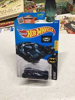 Photo of unopened Hot Wheels 2015 Dark Knight Batmobile die-cast car in original packaging showing the front of the card and the toy inside.