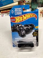 Photo of unopened Hot Wheels 2017 Justice League Batmobile in original packaging with blue backing and clear plastic blister.