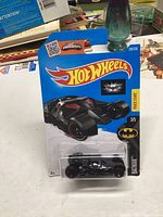 Photo of unopened Hot Wheels Dark Knight Batmobile 2013 packaging with the diecast model visible.