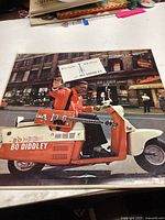 Front cover of vinyl LP record showing Bo Diddley on an orange and white scooter, album title 'Have Guitar, Will Travel'.