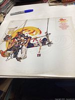 Front cover of Chicago's Greatest Hits album showing band members painting logo on swing set.