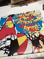 Front cover of vinyl record album 'Armed Forces' by Elvis Costello & The Attractions with colorful abstract artwork and album title.