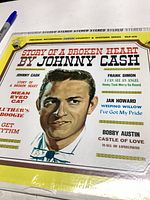 Front cover of vinyl LP record titled 'Story of a Broken Heart' by Johnny Cash showing portrait and track listing.