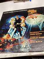 Front cover of the vinyl record featuring illustrated James Bond art from Diamonds Are Forever.