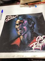 Front cover of Ry Cooder Get Rhythm vinyl record album showing illustrated portrait of Ry Cooder.