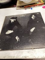 Front album cover of Seals and Crofts Year of Sunday showing two band members posing seated.