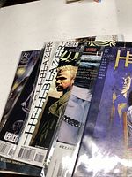 Seven Hellblazer comics displayed fanned out on a surface showing partial cover artwork