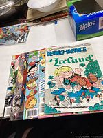 Top view showing seven assorted comic books including the Dennis the Menace Ireland issue.