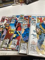 Six X-Men comic books laid out showing colorful cover art and series branding.