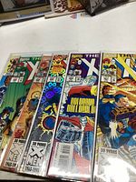 Photo showing six Marvel X-Men comic books with colorful covers, 30 years X-Men 1963-1993 logo, stacked together.