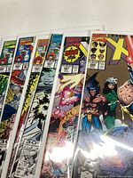 Front and partial stack of six Uncanny X-Men comic books showing their vibrant cover art and Marvel branding