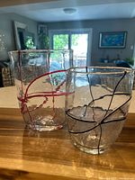 Photo showing both art glass vases side by side, highlighting clear textured glass and colored ribbons.