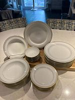 Full set displayed on table showing dinner plates, salad plates, soup and dessert bowls stacked separately