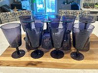 Set of 13 purple stemmed glasses arranged showing dappled texture and uniform size.