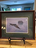 Front view of the framed art print showing the Great Blue Heron flying over water with island in background.