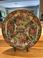 Full view of the shallow bowl/plate showing the overall Rose Medallion design with floral motifs and figures.