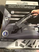 Box front showing Autoready brand handheld vacuum cleaner cyclone system with 6 accessory attachments illustrated including crevice tool, upholstery brush, vent brushes, carpet brush, extension bar, and flex hose