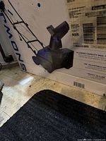 Snow Joe electric snow blower box showing label and some box damage.