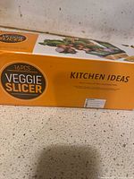 Box showing brand Kitchen Ideas and the 16-piece Veggie Slicer set.