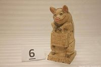 Image of antique cast iron pig bank with number 6 beside it for reference