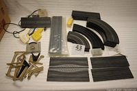 Full overview of all track pieces and accessories laid out showing the variety including power tracks, curves, and straight pieces.