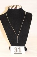 Photo showing the sterling silver necklace with cross pendant displayed on black bust with lot number 31 visible.