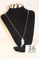 Full view of sterling silver necklace on black display with pendants