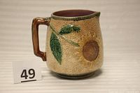 Side view showing sunflower pattern and handle detail.