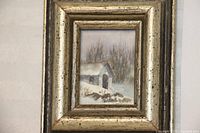 Front view of the framed miniature watercolor painting depicting a winter scene with a cabin and bare trees.