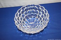 Top view of the clear raspberry-shaped crystal bowl showing concave interior and bubble pattern on the surface.