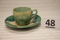 Cup and saucer set shown from a side angle highlighting the overall shape and pattern detail.