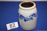 Full view of stoneware crock showing shape, size, and blue decorative band.