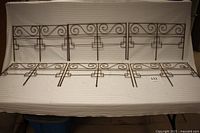 Full view showing all six vintage metal garden fence sections laid out horizontally.