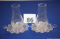 Two clear Federal Glass candle chimneys with matching bases on neutral background with item number