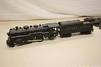 Engine 1666 locomotive connected to coal tender labeled 'Lionel Lines', showing build details and numbering on side of engine