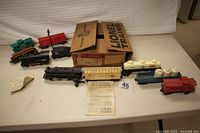 Overall layout showing both locomotive engines, tenders, caboose, rolling stock, transformer and tracks on table