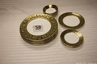 Full display of the set showing all plates and bowls with dark green and gold dragon ornamental banding.