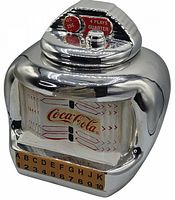 Photo showing full front view of the Coca-Cola Jukebox cookie jar with chrome finish, red and white Coca-Cola logo, and jukebox styled front panel with letter and number buttons.