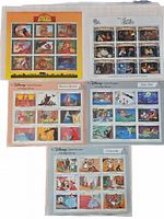 Five sealed sheets of Disney-themed postage stamps featuring The Lion King, Beauty and the Beast, Sleeping Beauty, Pinocchio, and Cinderella.