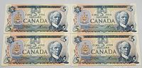 Front side of the four 1979 Canadian five dollar bills showing the portrait of Sir Wilfrid Laurier and Canadian coat of arms.