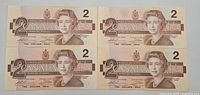 Four Canadian two dollar bills front side view showing Queen Elizabeth II portrait