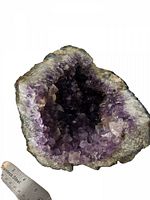 Top view of the amethyst geode showing the deep purple crystal cluster interior with varying crystal sizes.