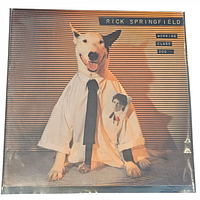 Front cover of Rick Springfield's 'Working Class Dog' vinyl album showing a dog wearing a shirt and tie.