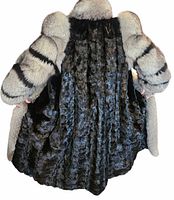 Back interior side of the fur coat showing the black mink fur lining and the fox fur sleeves and collar, highlighting the texture and condition of the fur interior.