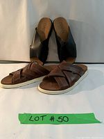 Two pairs of Camper leather sandals, one brown with woven straps and white soles, one black crossover strap slide.