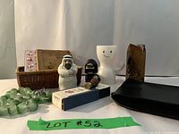 Wide view of all items including books in basket, figurines, candle holders, beads, seal stamp, and black pouch