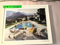 Front view of framed photograph showing two women at poolside with mountain background