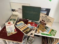 Complete collection of vintage North American travel brochures, guide books, and maps arranged on a surface showing different titles and sizes.